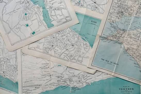 Overlapping vintage topographic and nautical maps showing coastal regions with turquoise water bodies and detailed geographic features